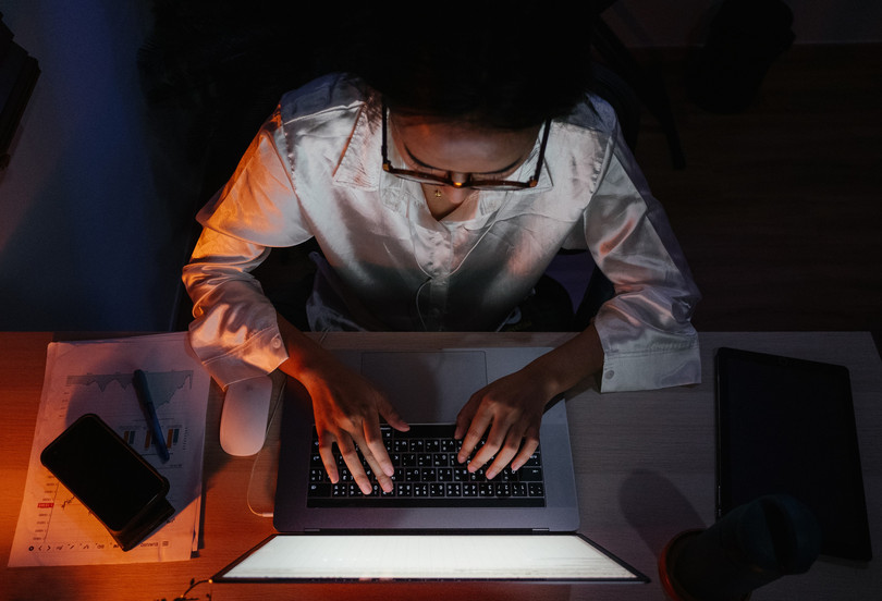 <span class='tighten-13'>Woman working late from home.</span>